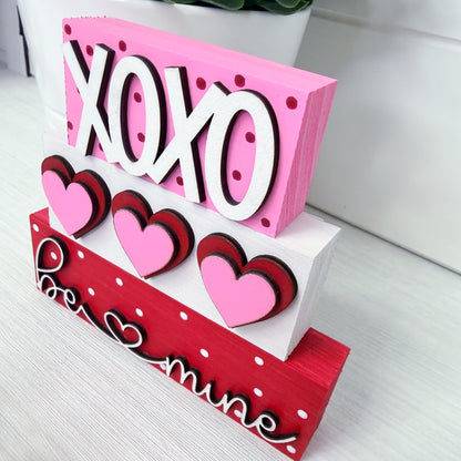 Decorative sign with 'XOHO' and heart designs on a white surface