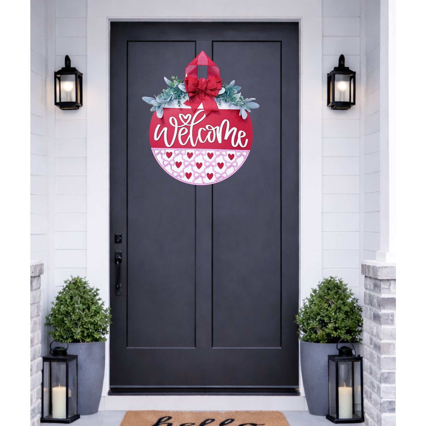 Decorative 'Welcome' door decal on a black door with plants and lanterns.