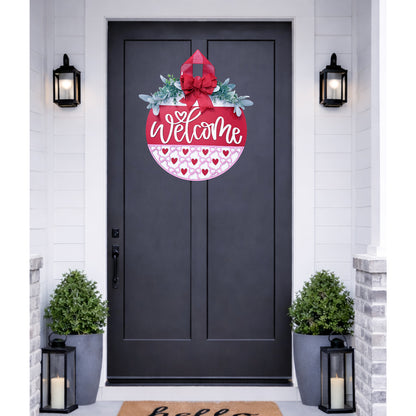 Decorative 'Welcome' door decal on a black door with plants and lanterns.