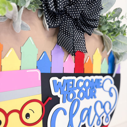 colorful 'Welcome to our Class' door hanger with crayon and eyeglasses design.