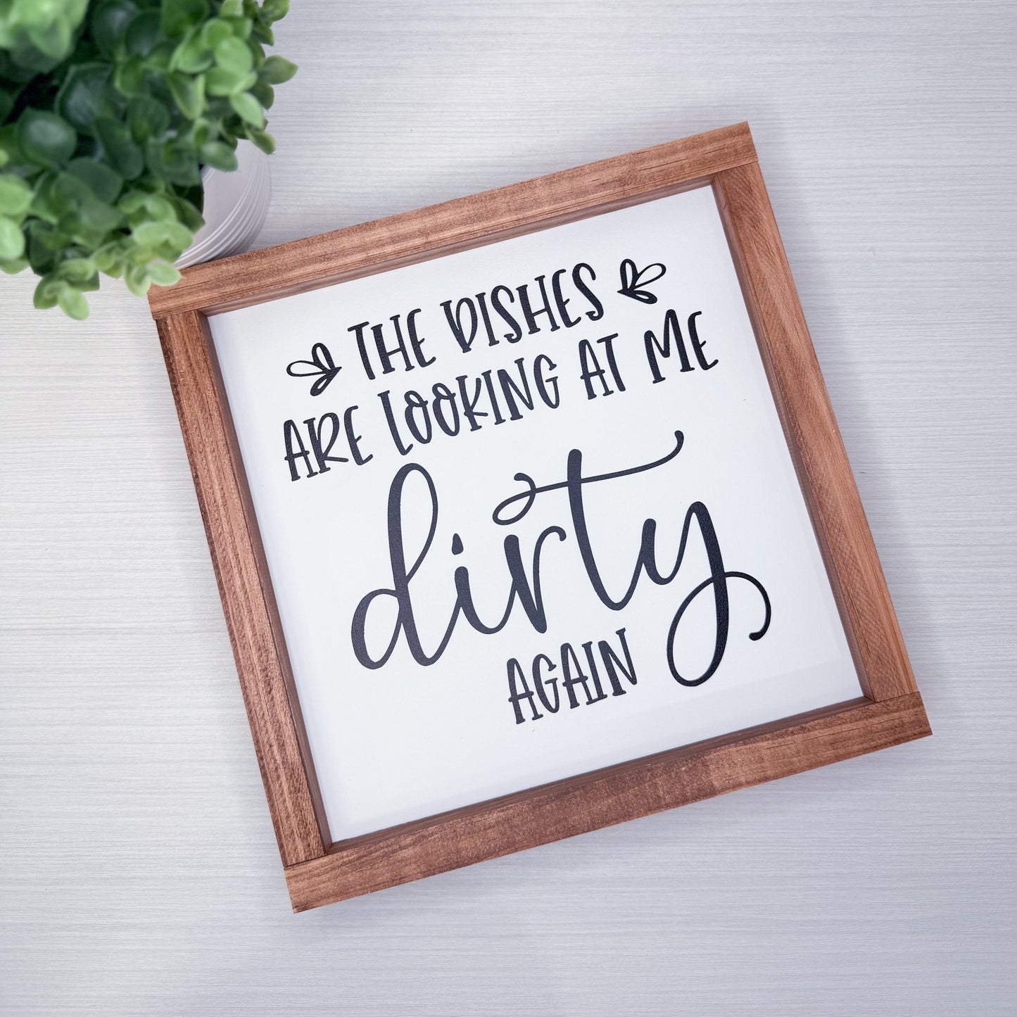 Framed sign with humorous text on a light background