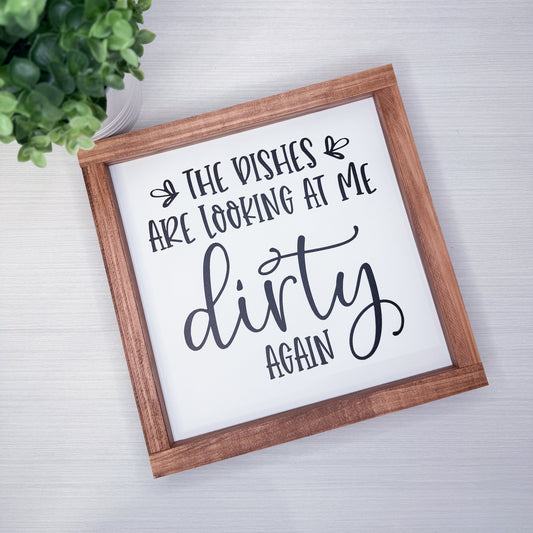 Framed sign with humorous text on a light background