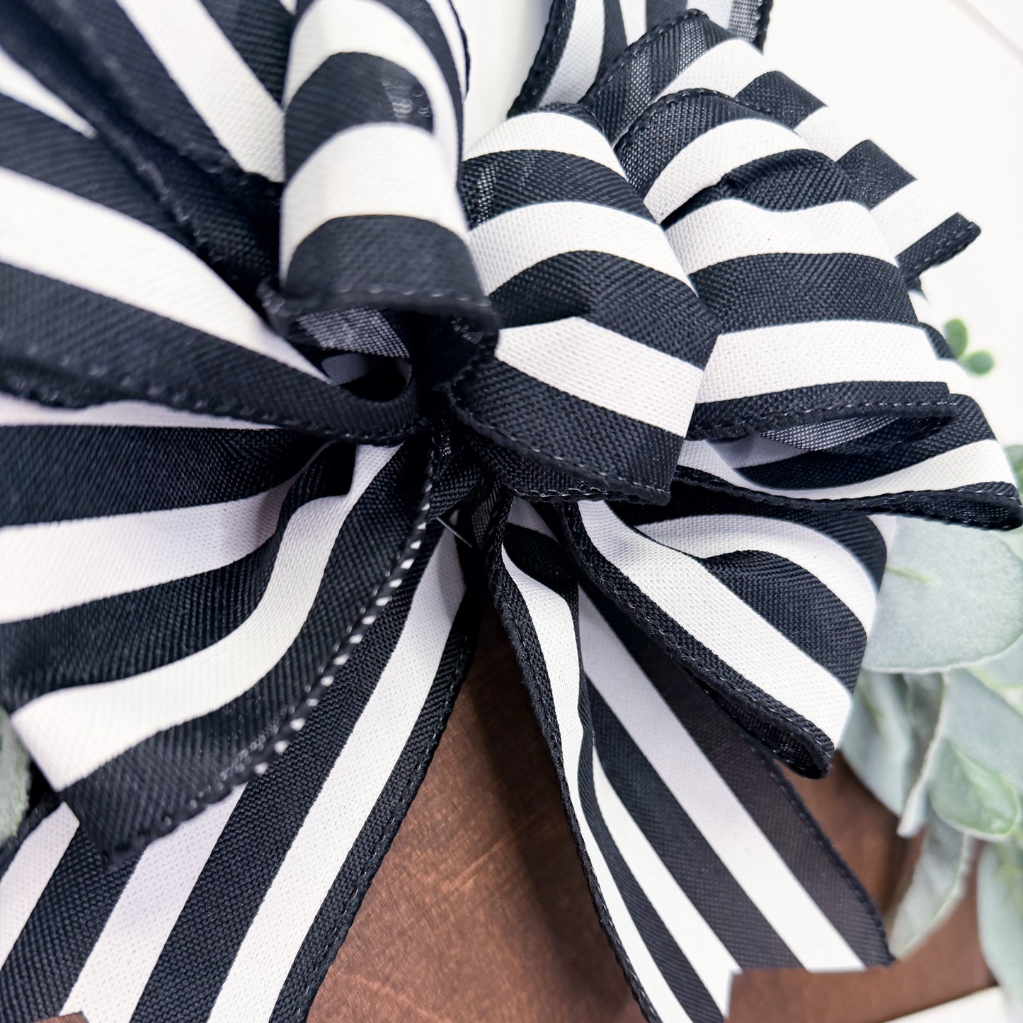Close-up of a black and white striped bow with a blurred background