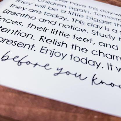 Text on a piece of paper with a wooden surface underneath