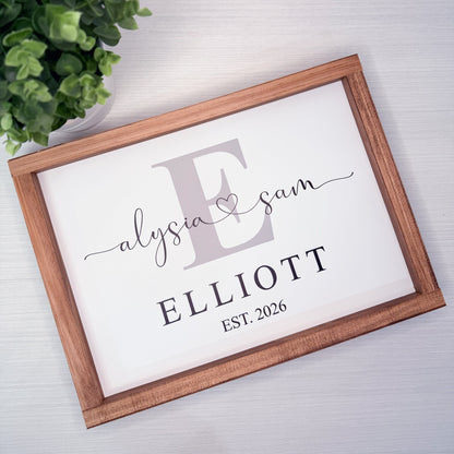 Framed print with 'Elyasia & Sam Elliott EST. 2026' on a light background