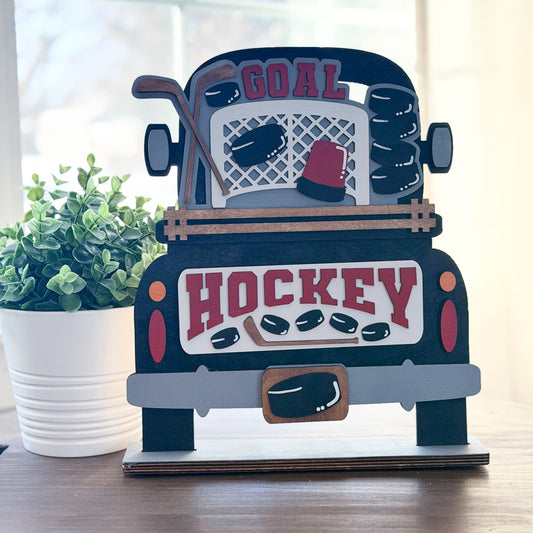 Hockey-themed decorative sign with a truck design on a wooden surface.