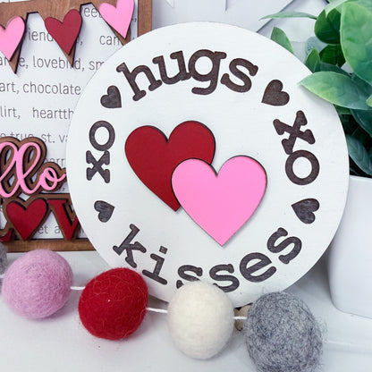 Decorative sign with hearts and text on a white background