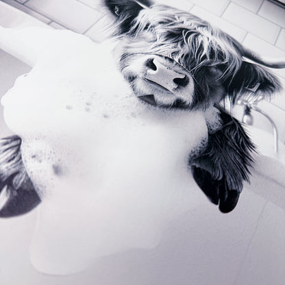 Highland cow in tub covered in soap suds.