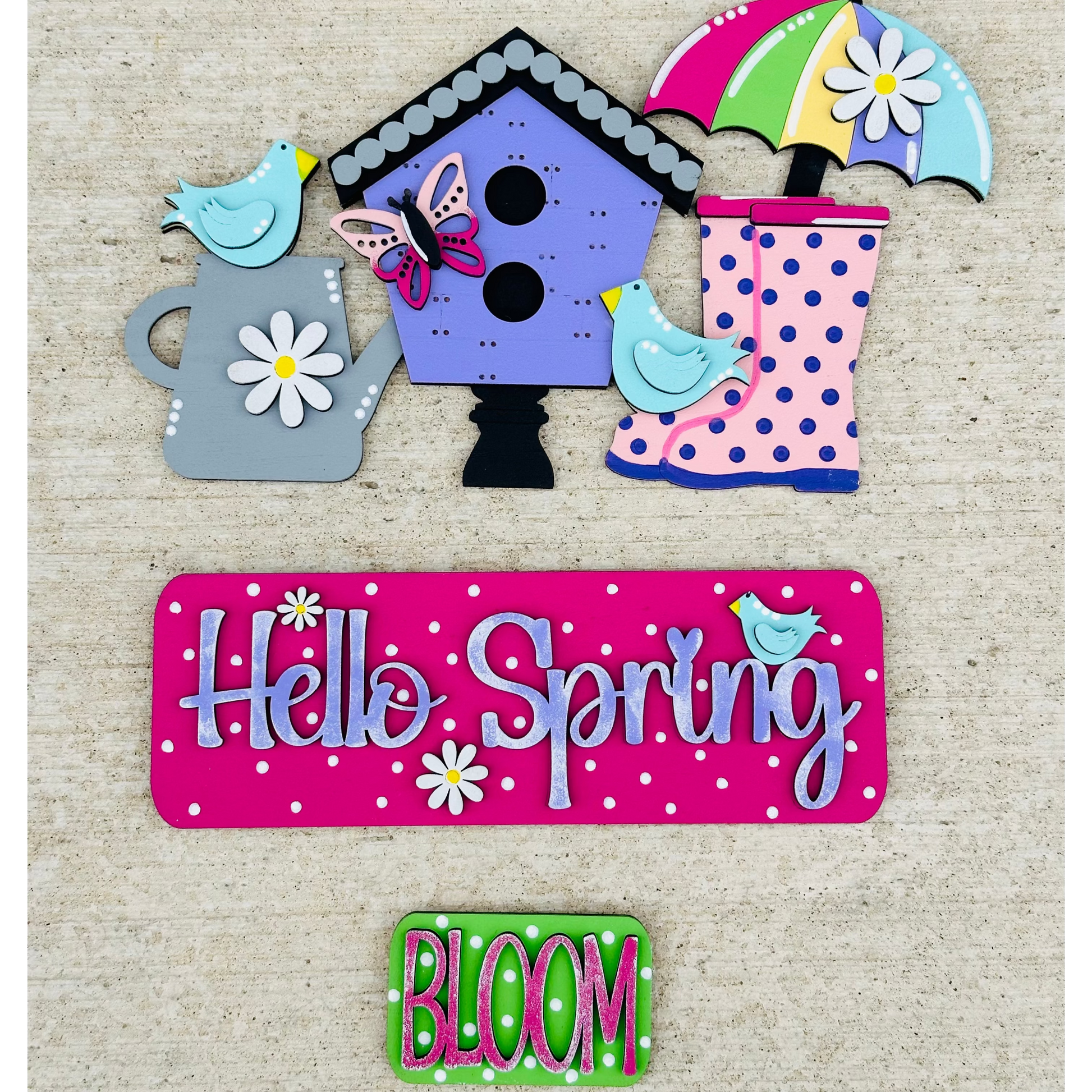 A decorative wood insert featuring a vintage truck with a birdhouse on the back, displaying the text 'Hello Spring' and various floral and polka dot patterns.