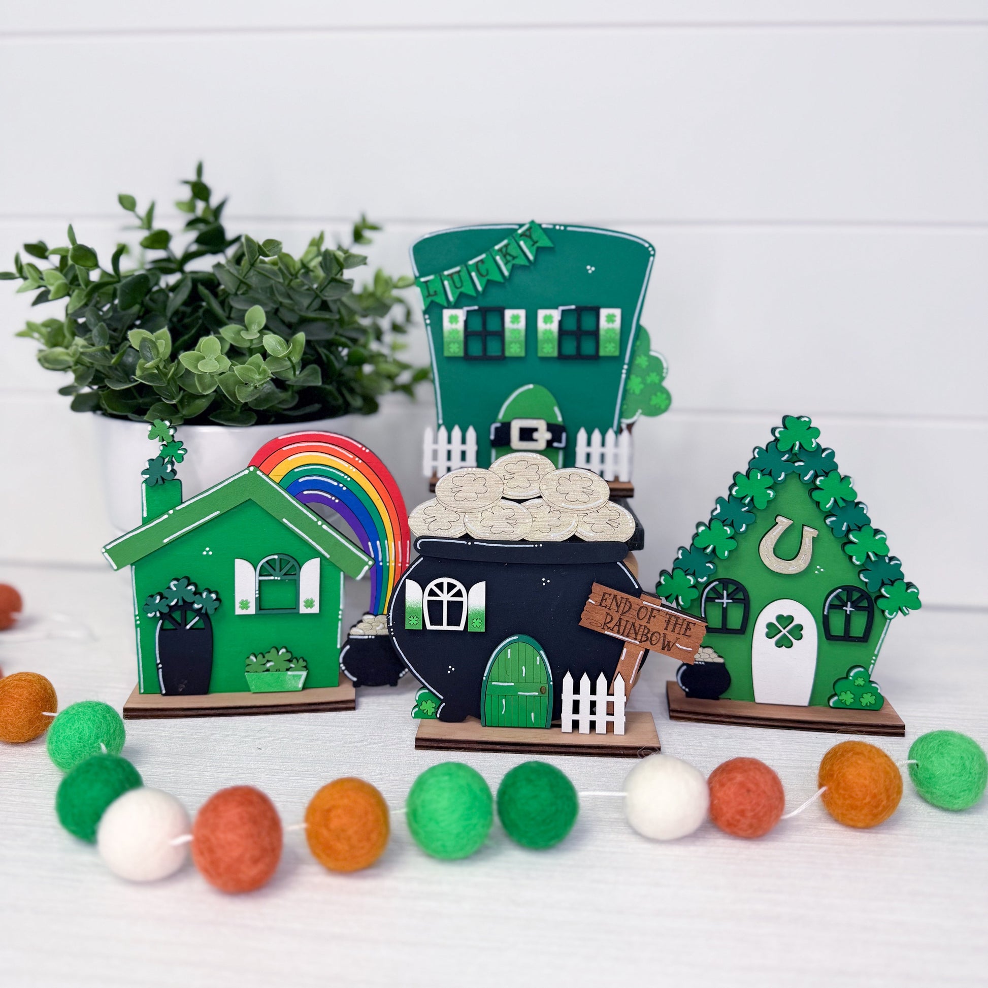 Set of decorative fairy houses with a rainbow and cloud on a white background