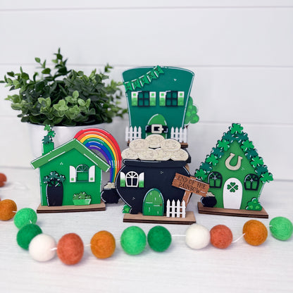 Set of decorative fairy houses with a rainbow and cloud on a white background