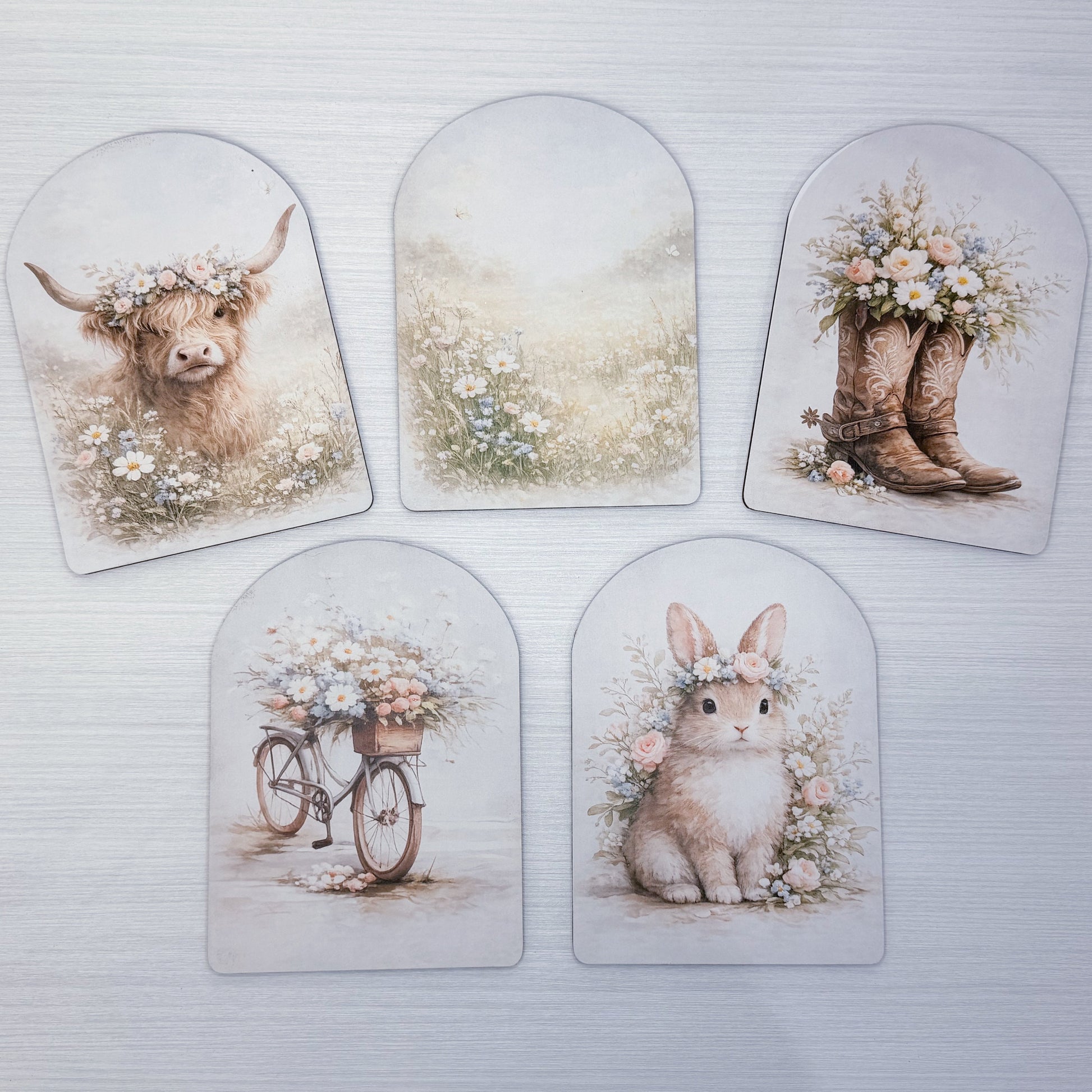 Set of five decorative arch's featuring animals and floral designs on a white background