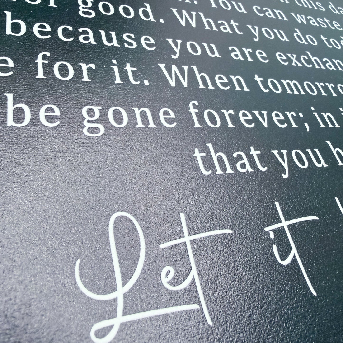 Text on a textured surface with 'Let it' in cursive