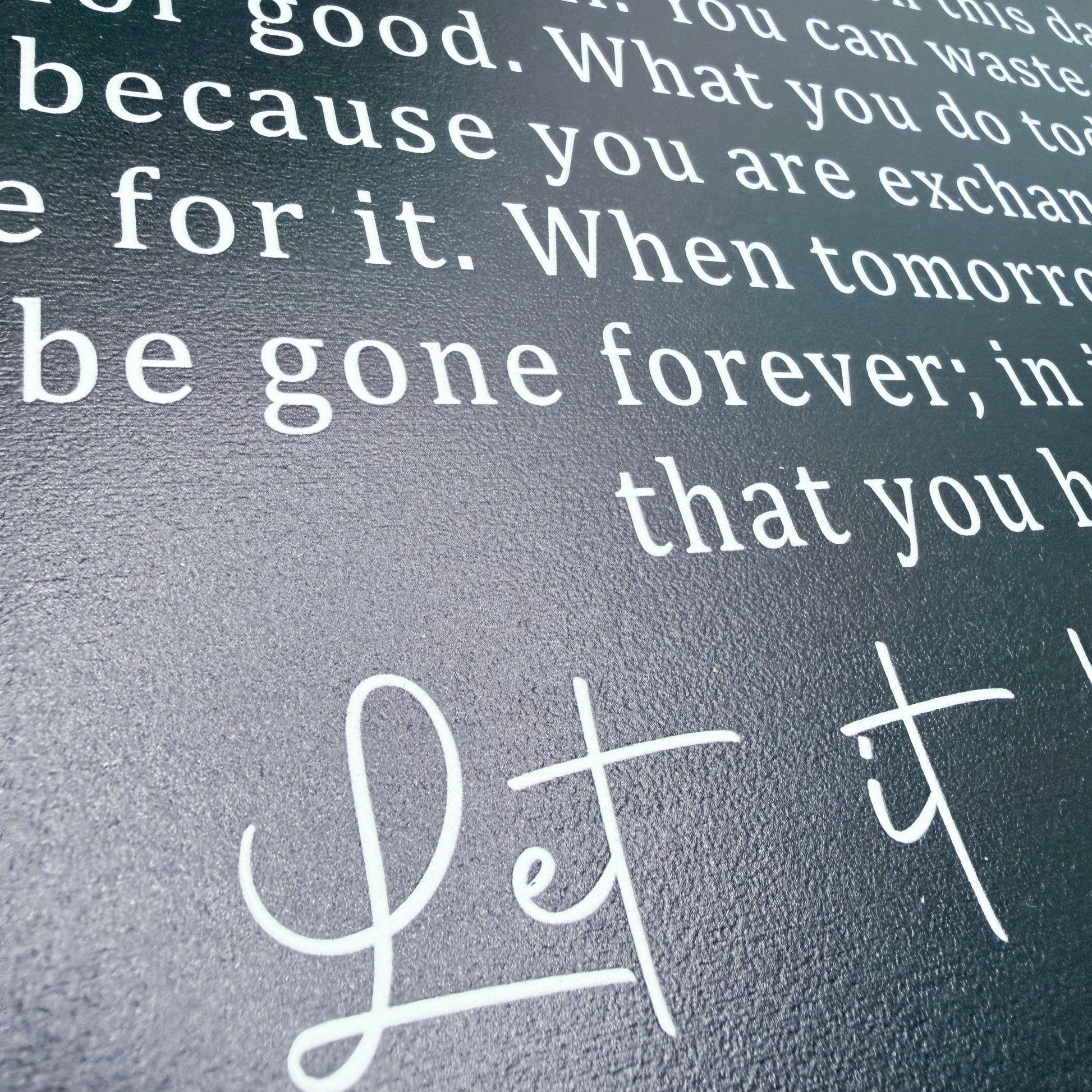 Text on a textured surface with 'Let it' in cursive