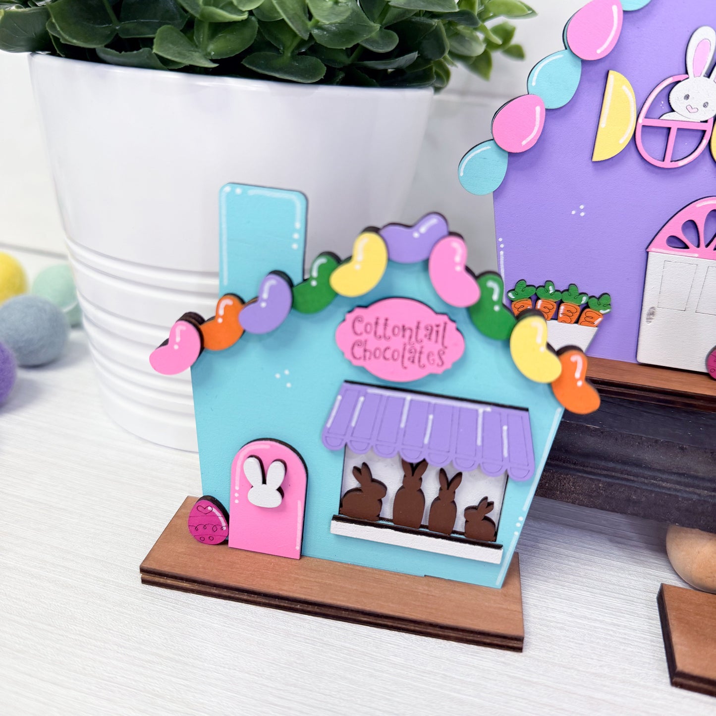 Colorful chocolate shop model with bunny figures on a white surface