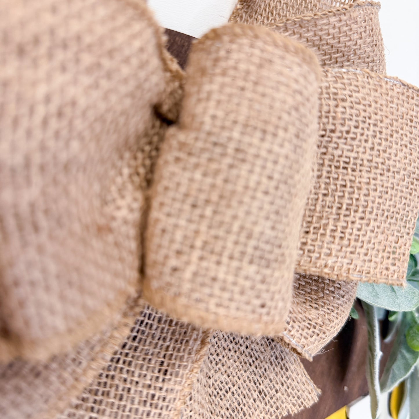 Close-up of a decorative wreath with burlap texture