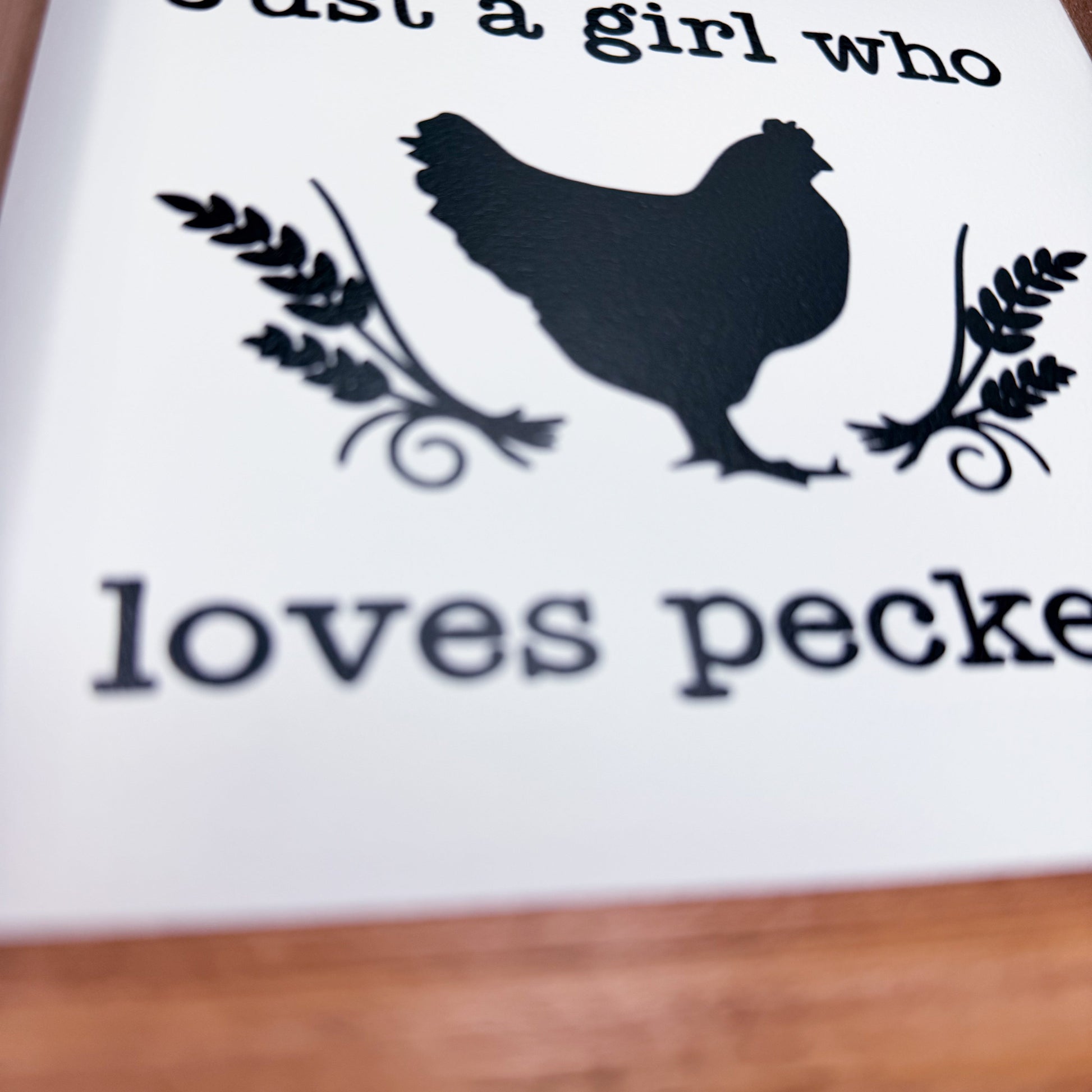 Silhouette of a rooster with text 'Just a girl who loves peck' on a white background.