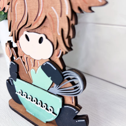 Wooden character with a chef's hat, holding a bowl and whisk, on a white background