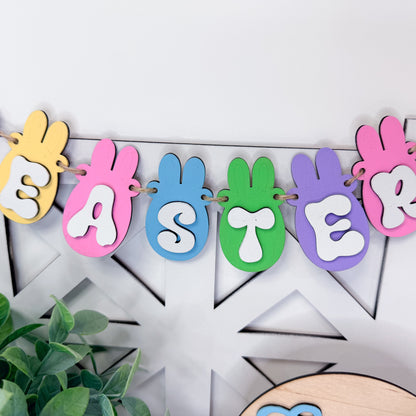 Colorful Easter banner with bunny shapes on a white wooden background