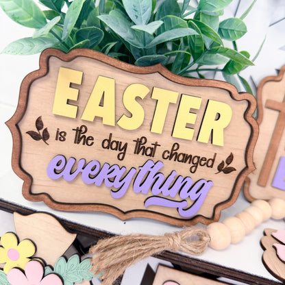 Wooden Easter sign with decorative elements on a white background