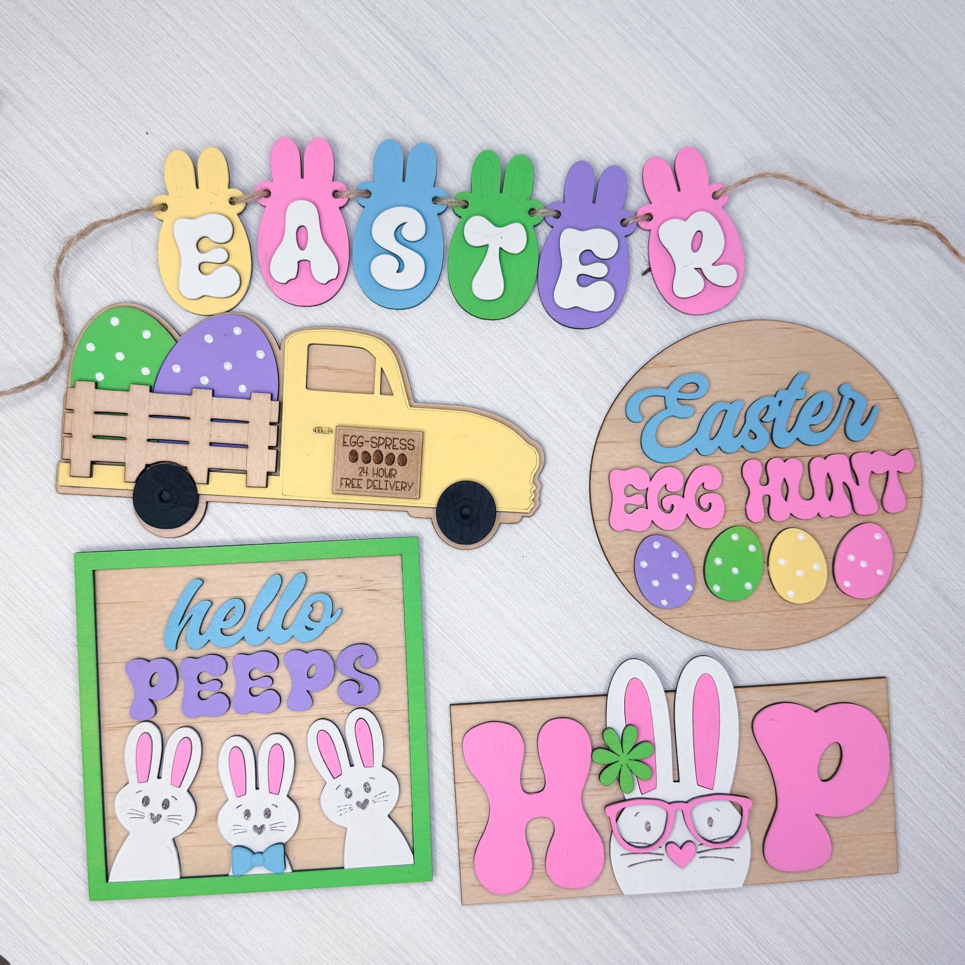 Set of colorful Easter-themed wooden signs on a white background
