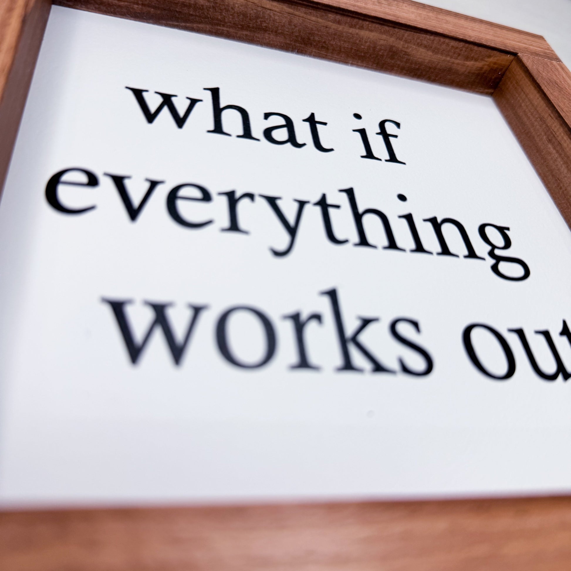 Wooden frame with text 'what if everything works out' on a white background