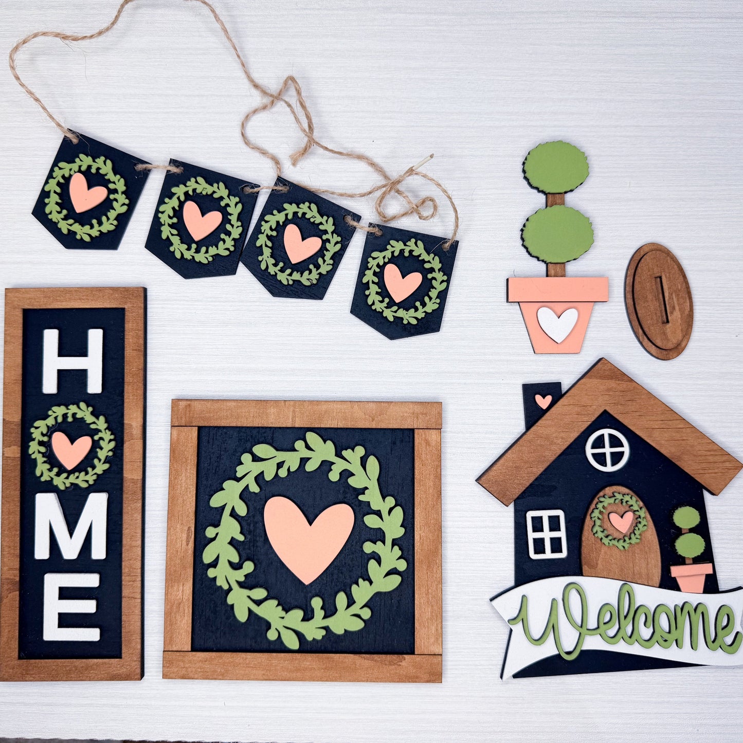 Decorative home decor items with hearts and wreaths on a white background