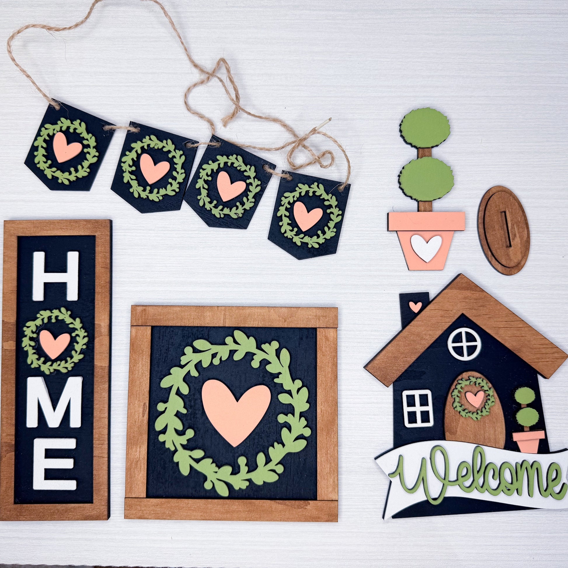 Decorative home decor items with hearts and wreaths on a white background
