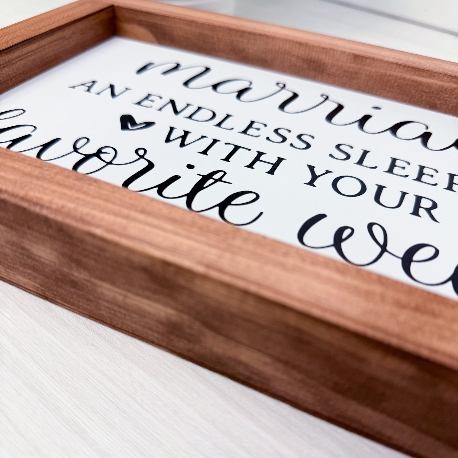 Wooden tray with white placemat featuring black text on a white surface