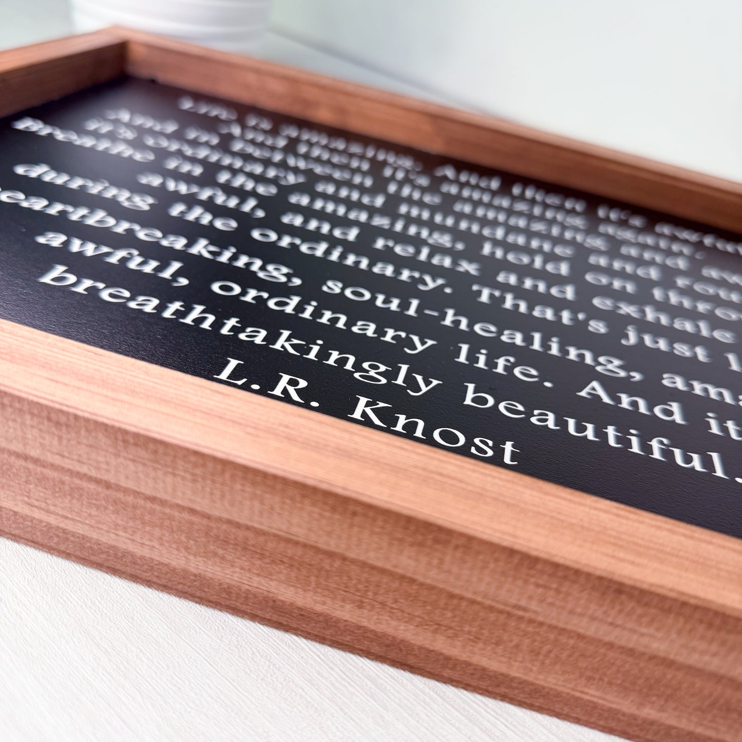 Wooden sign with text on a white surface