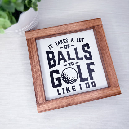 Framed sign with humorous golf quote on a light background
