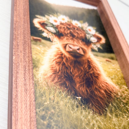 Framed picture of a Highland cow with a flower crown in a grassy field