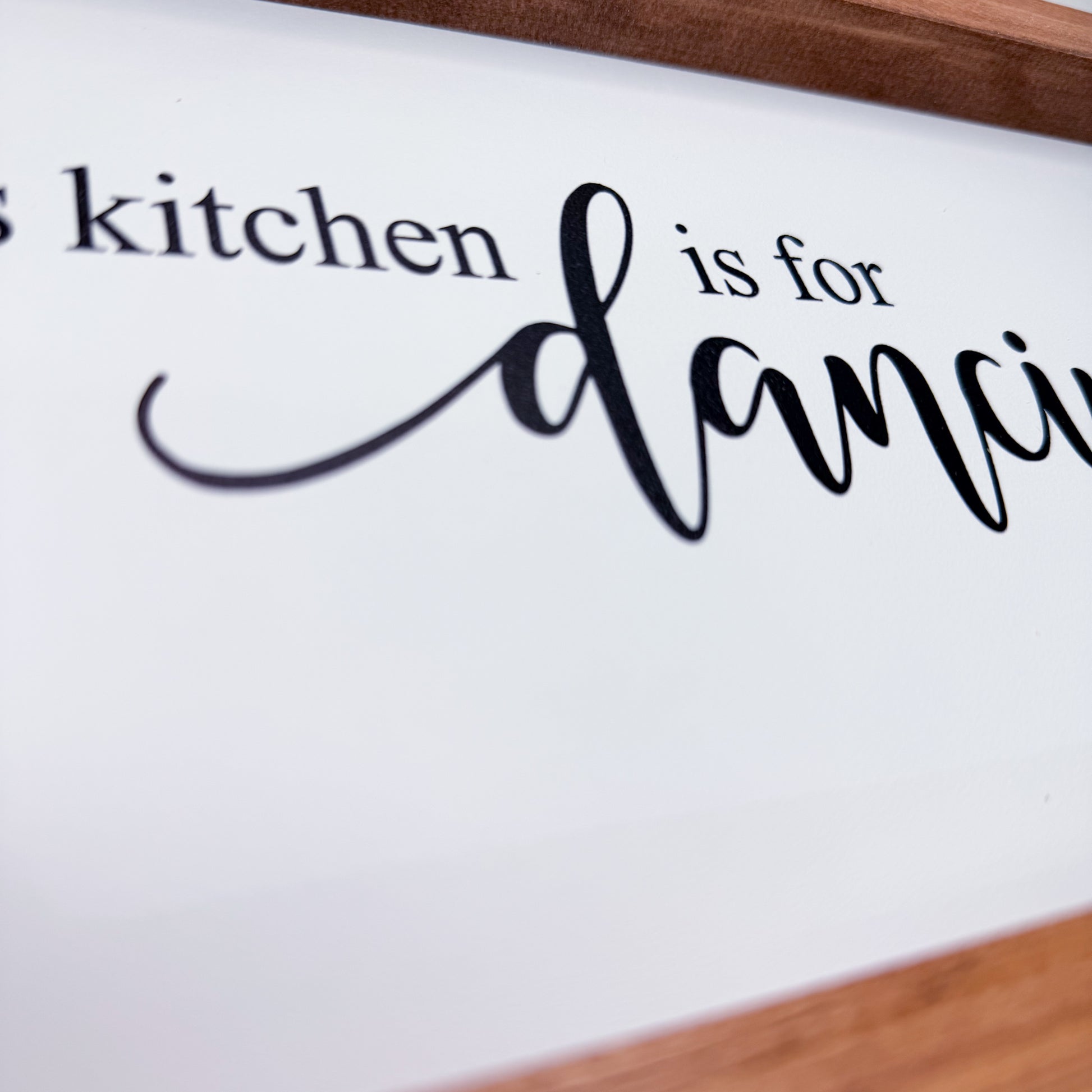 Decorative sign with text 'kitchen is for dancing' on a white background