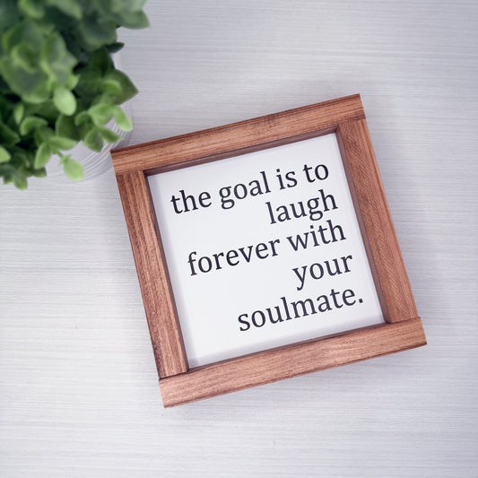 Wooden frame with motivational quote on a light background