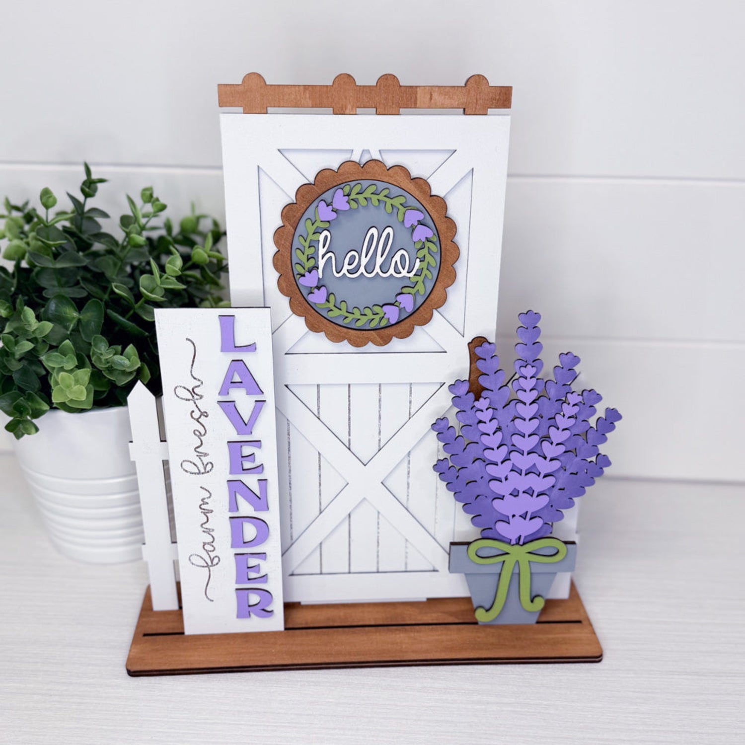 Decorative sign with 'hello' and lavender design on a white background