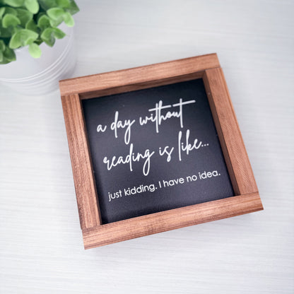 Small framed sign with humorous quote on a light background