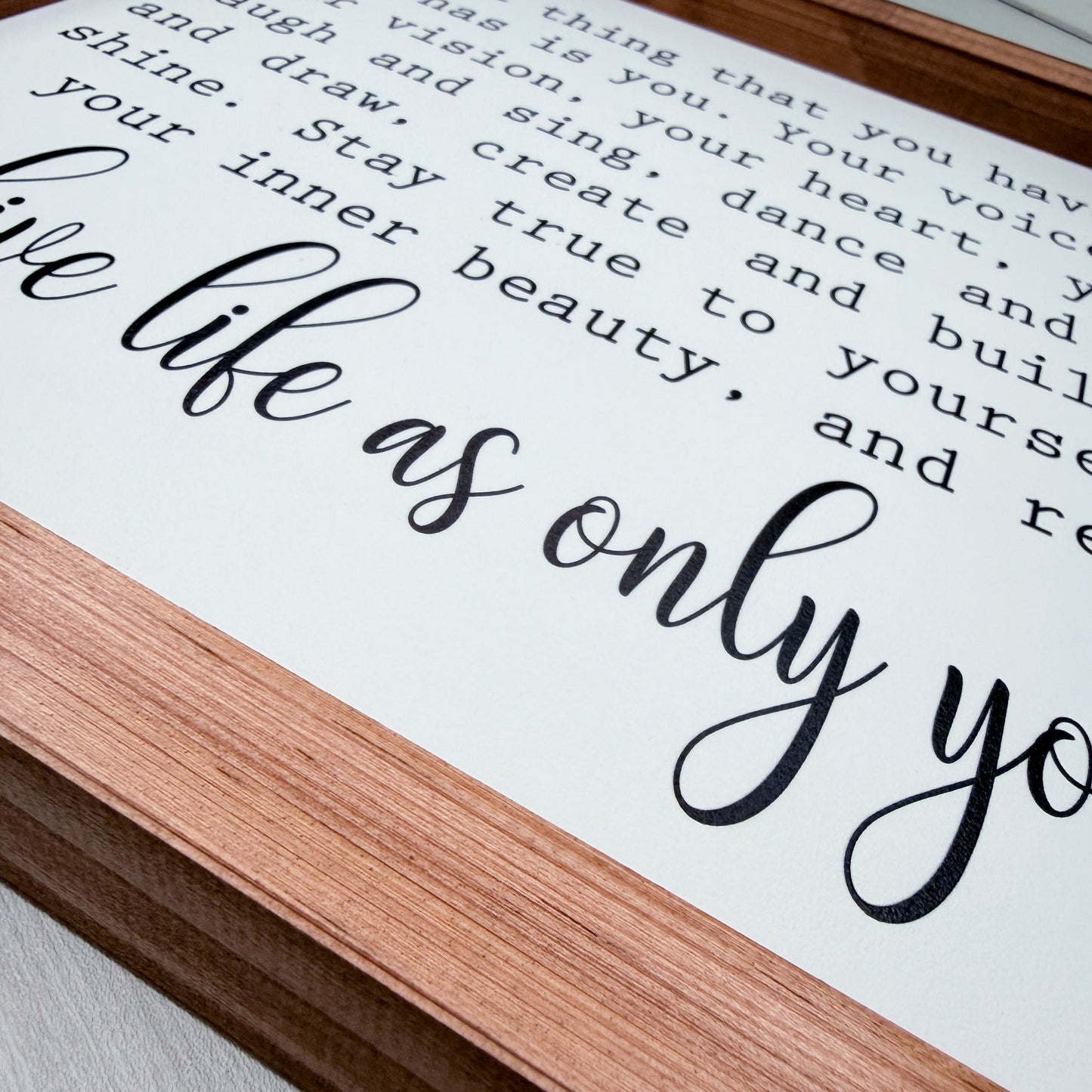 Wooden frame with motivational quote on a white background