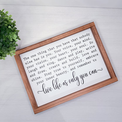 Framed motivational quote on a white background with a wooden frame