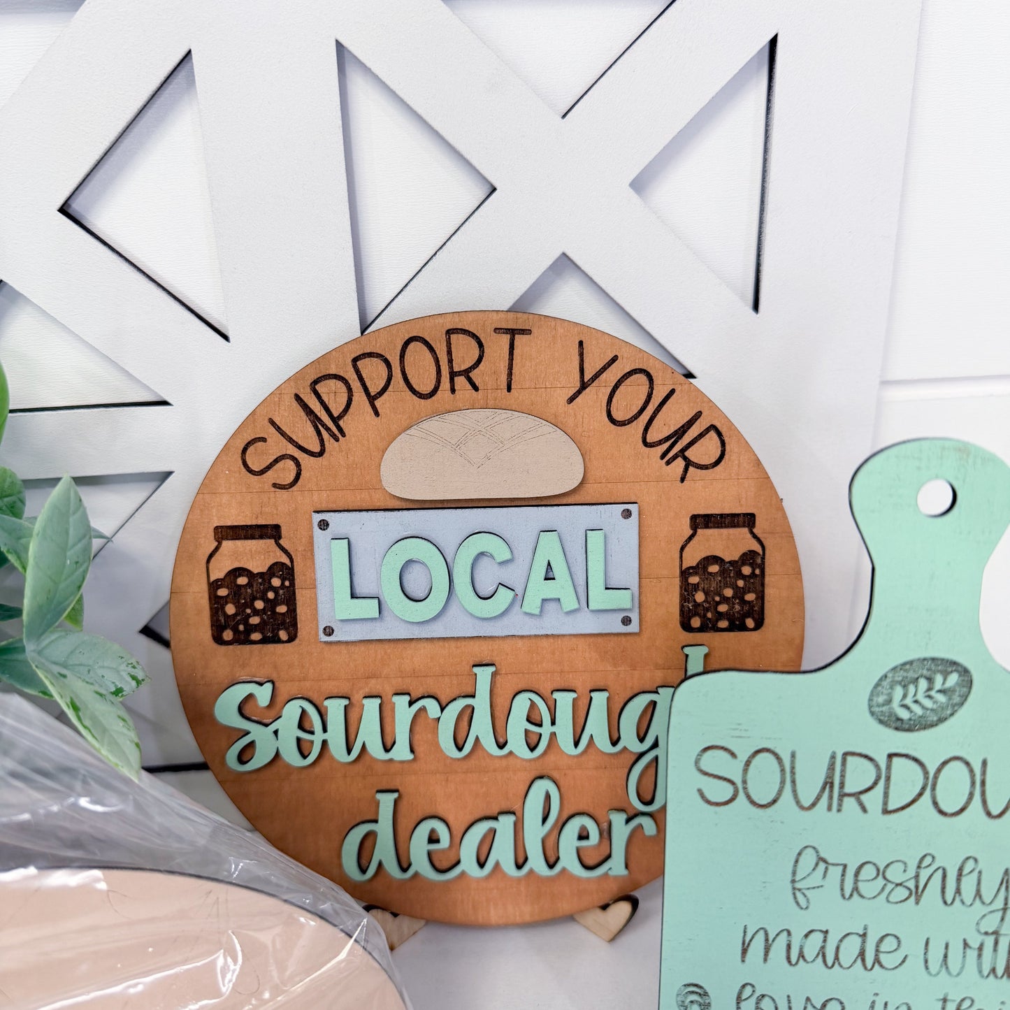 Wooden sign with 'Support your local sourdough dealer' text on a white background