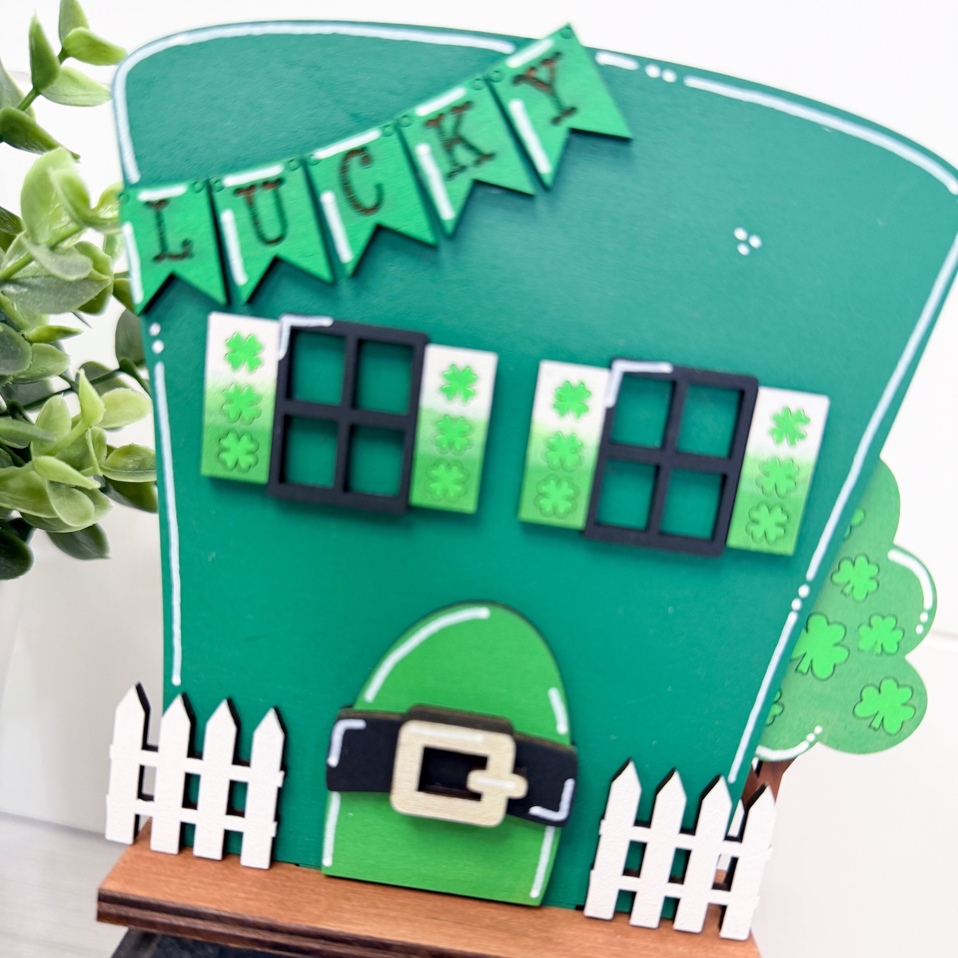 Green door with 'LUCKY' banner and shamrock decorations on a white background