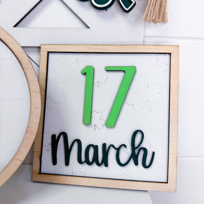 Framed sign with '17 March' text on a white background