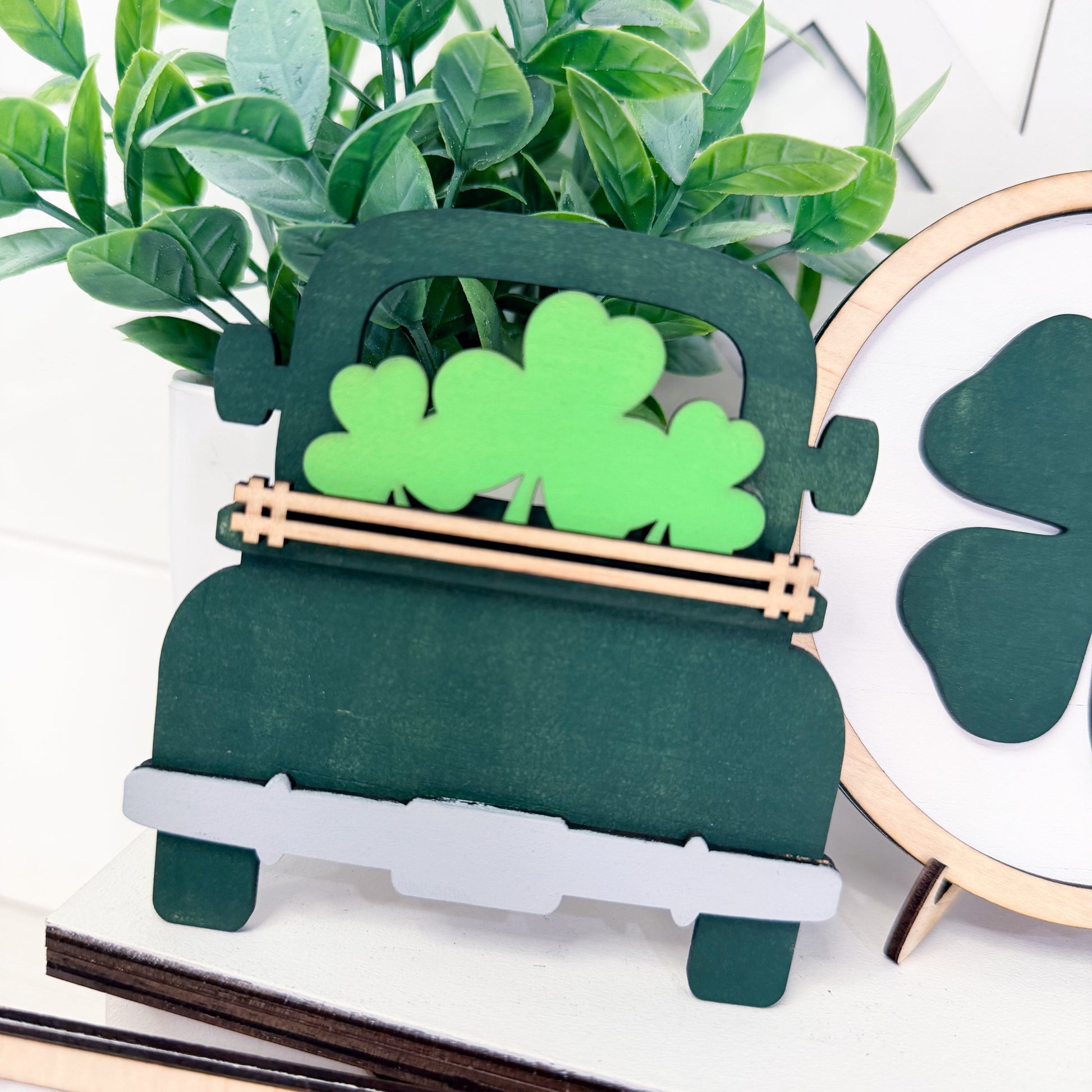 Decorative truck with green clover design on a white surface