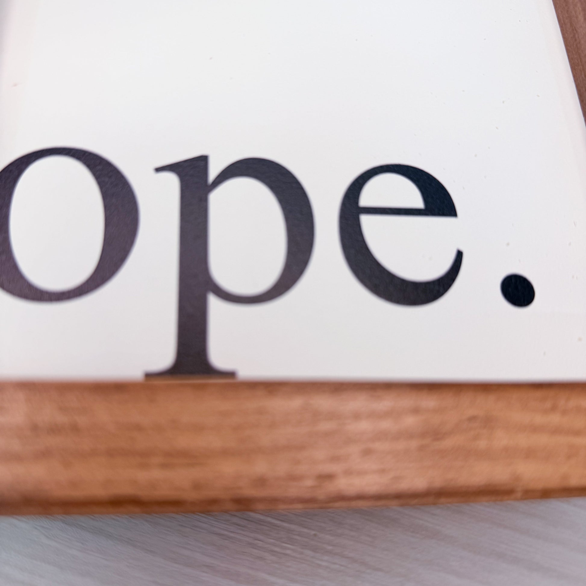 Wooden sign with the word 'ope' on a white background