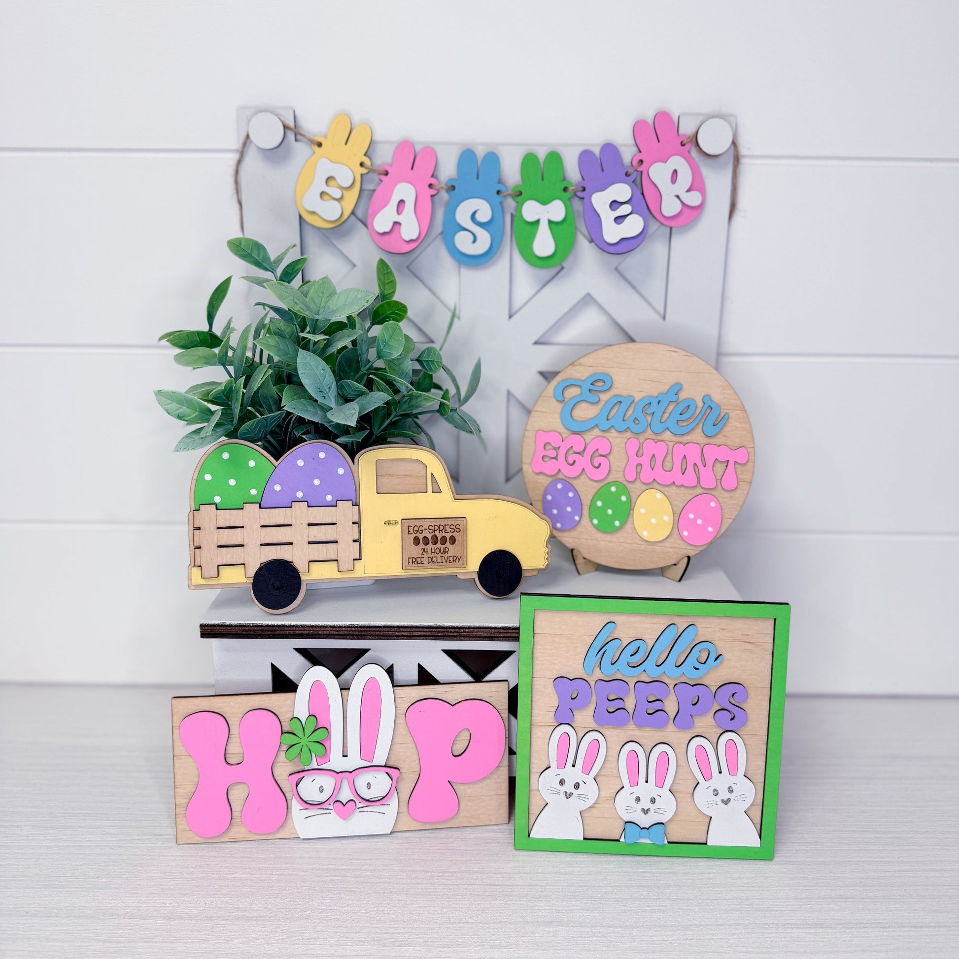 Collection of Easter-themed wooden signs and decorations on a white background