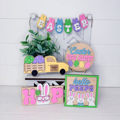 Collection of Easter-themed wooden signs and decorations on a white background