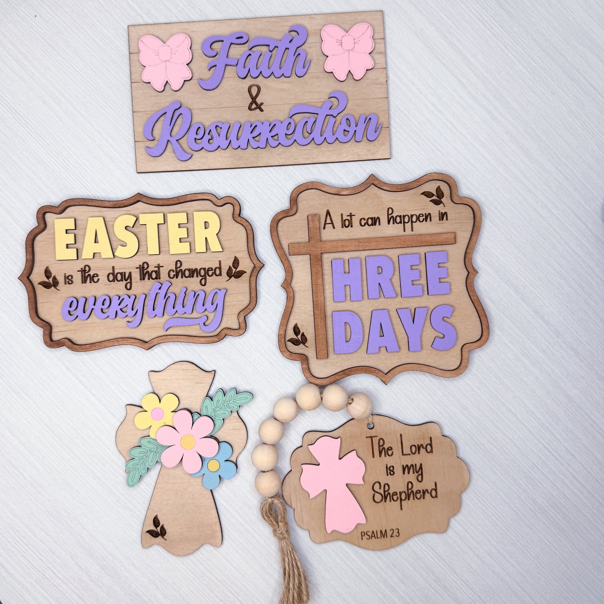 Set of wooden signs with Easter and religious-themed sayings on a white background