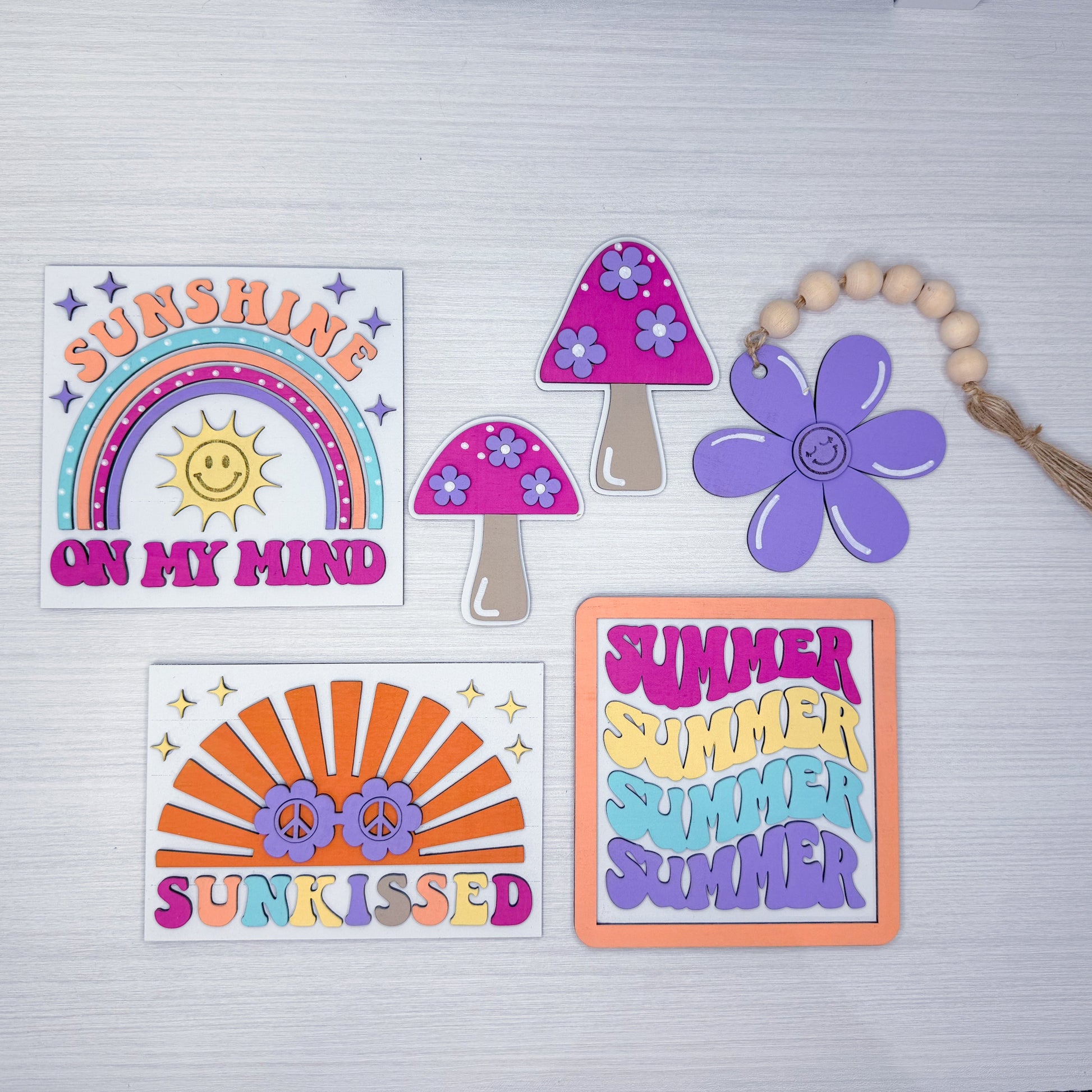 Set of colorful summer-themed stickers on a light gray background