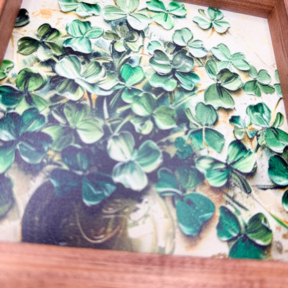 Decorative sign with green leaf pattern and wooden frame