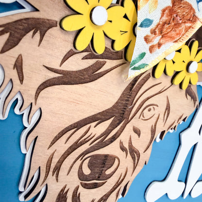 cow design and decorative flowers on a blue background