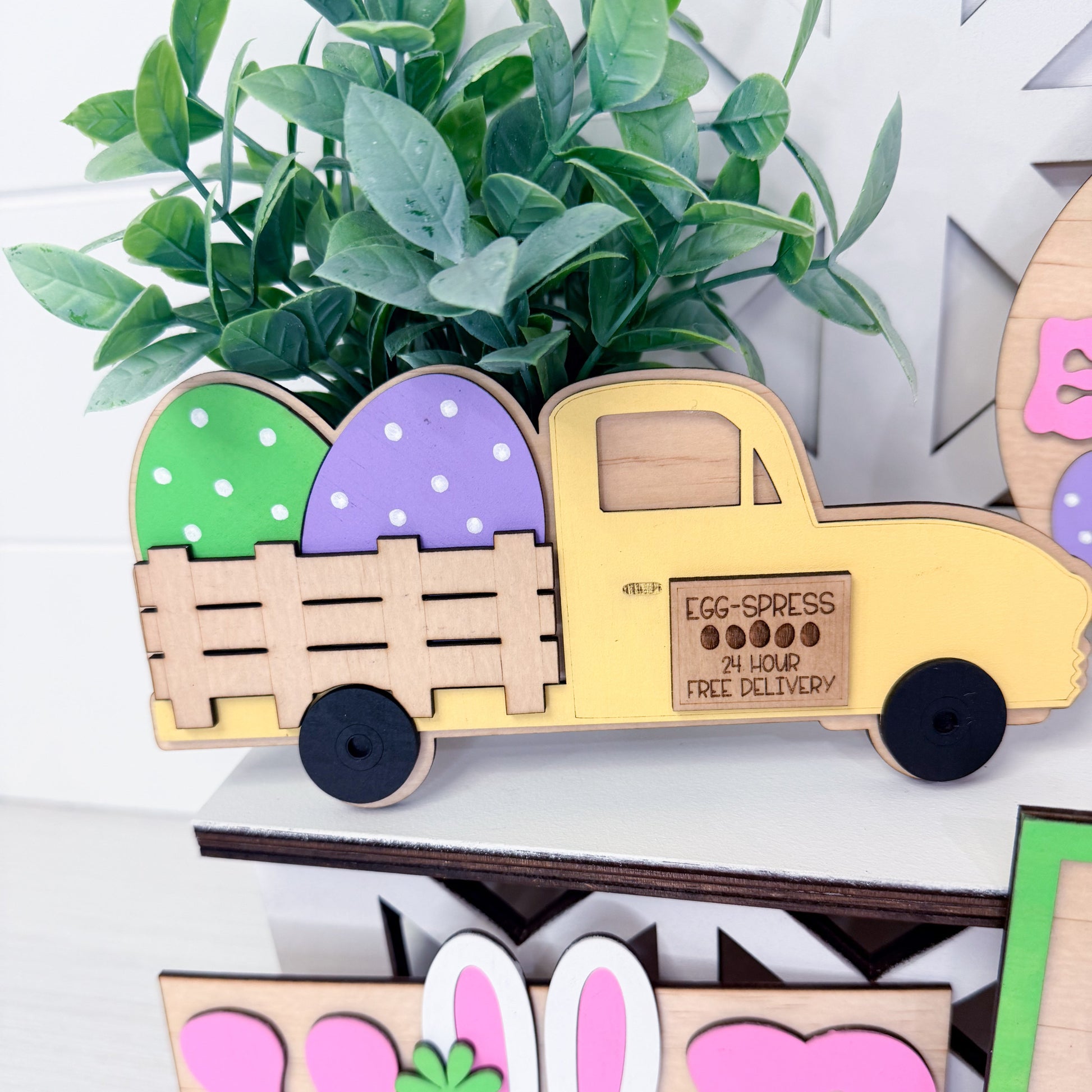 Wooden truck with Easter eggs and a plant on a decorative shelf